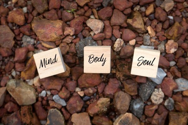 top-view-of-wooden-cube-written-with-mind-body-soul-on-a-brown-rock-background-life-background_t20_gLe9y8